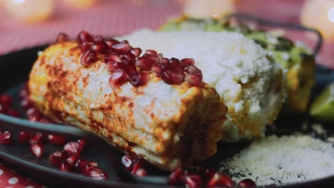 Careful cooking study: arranging colorful elote on a dark plate Stock Footage 342172277