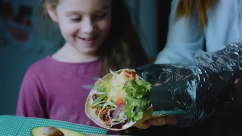 Careful ingredient view: child tasting a homemade burrito Stock Footage 342168392
