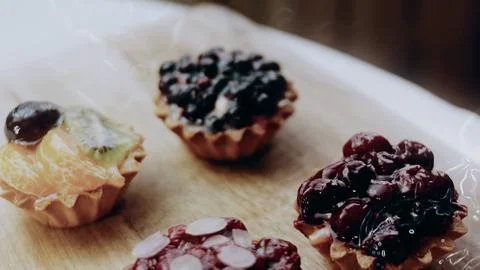 Careful plating process view: arranging assorted tartlets in neat rows Stock Photos