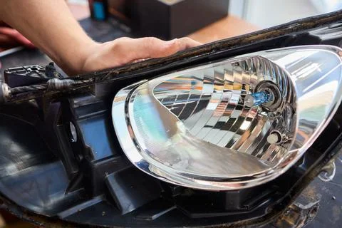 Careful precision is essential when installing a car headlight assembly for 스톡 사진