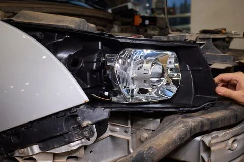 Careful precision is essential when installing a car headlight assembly for 스톡 사진