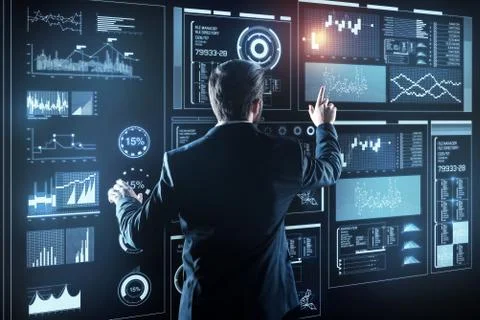 Careful programmer standing in front of a screen while working with information Stock-Fotos