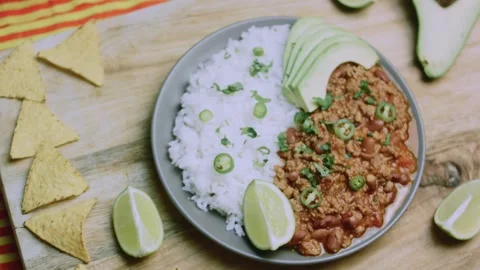 Careful recipe study of complete chili con carne with rice and avocado Stock Footage 342153547