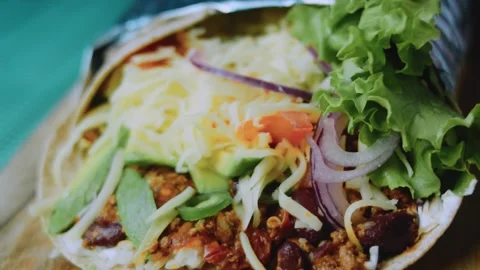 Careful serving view: cutting a burrito to reveal its layers Stock Footage 342168216
