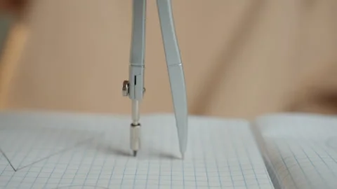 Careful student drawing with precise compass work. Dedicated student Stock Footage 341977114
