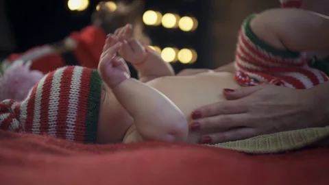 Carefull mother is softly stroking her baby boys' tummy while he is awaking Stock Footage 86525019