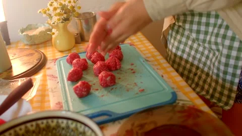 Carefully preparing delicious meatballs on a kitchen counter for cooking Stock Footage 318923370