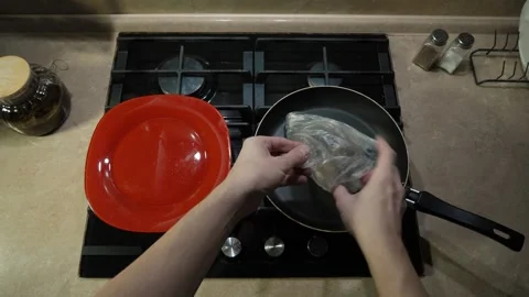Carefully preparing ingredients for cooking in the kitchen Stock Footage 307616392