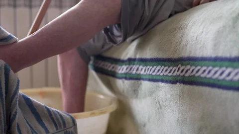 Caregiver is gently drying the leg of an elderly man. Support and care bein.. Video stock 306085111