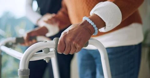 Caregiver, help and hands with walker in nursing home, rehabilitation or su.. Stock Photos