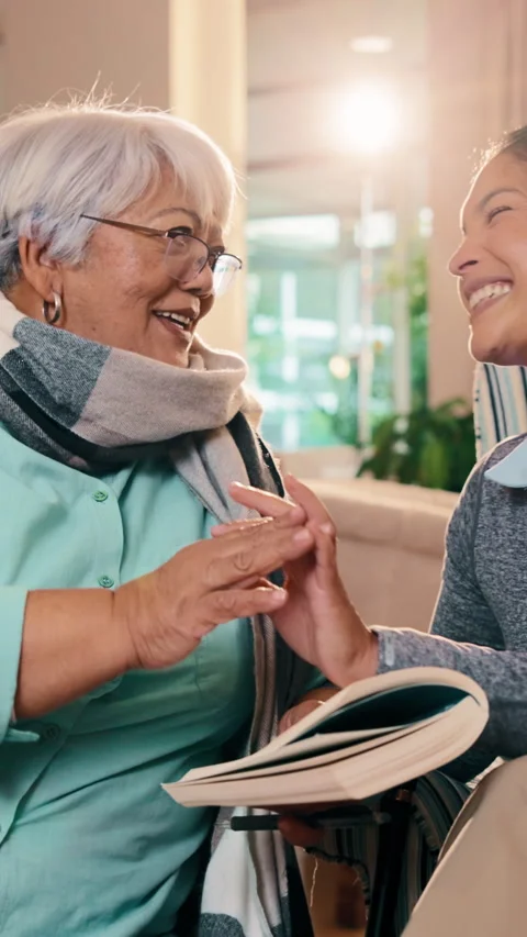 Caregiver, high five and senior woman in home with book, word search and Stock Footage 341482971