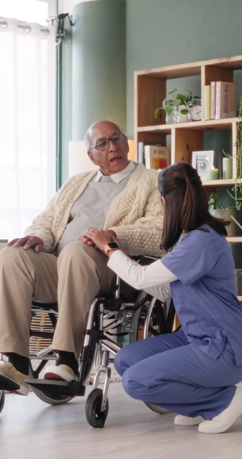 Caregiver, support and old man in nursing home with wheelchair, discussion or Stock Footage 335908335