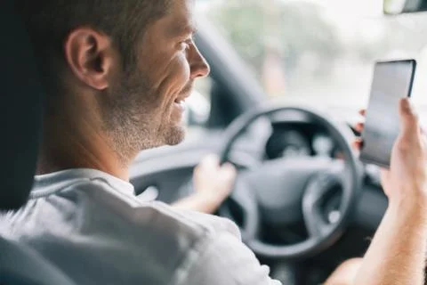 Careless driver using a mobile phone whilst driving Stock Photos