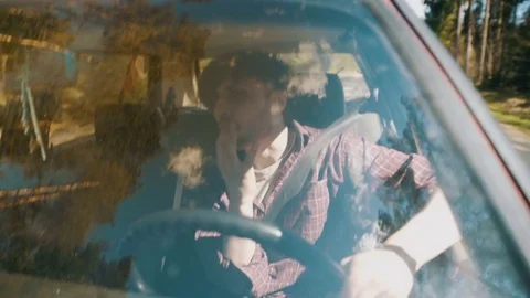 Careless driver who's eating snacks while driving Stock Footage 83223883