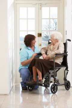 Carer With Disabled Senior Woman Sitting In Wheelchair Stock Photos