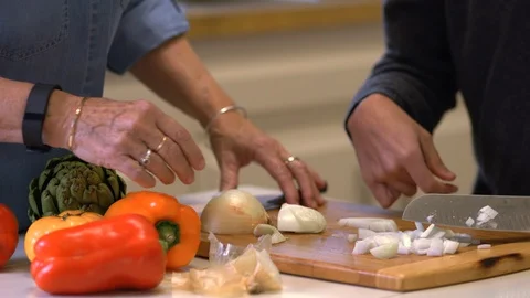Carer helping a young man with a disability to prepare a meal. Stockbeeldmateriaal 88374896
