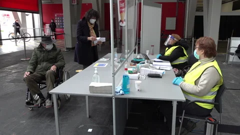 Caretaker and elderly man in voting station, general elections Covid-19 Video stock 151381447