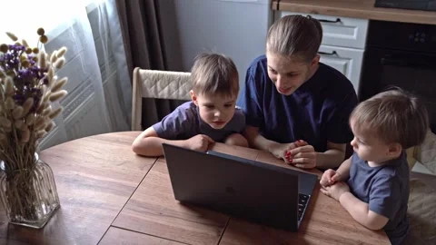 Caretaker using technology among kids. White adult navigating online world with Stock Footage 336972924