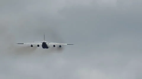 Cargo aircraft climbing into cloudy sky after takeoff Stock Footage 346180194