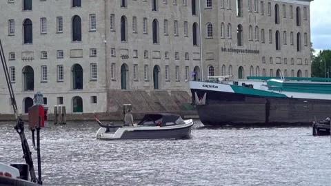 Cargo and excursion boats navigating amsterdam's maritime museum Stock Footage 313109897