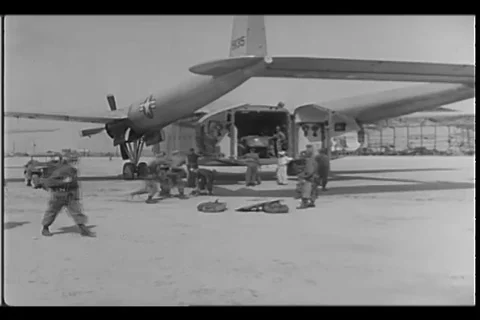 Cargo and passenger plane unload fantom boat at Kimpo Air Force Base - 1950 Stock Footage 99782460