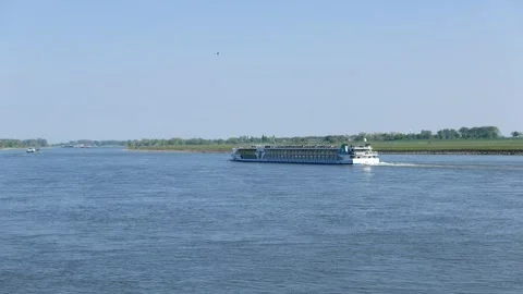 A cargo and passenger river ship is sailing up the Rhine River. Stock Footage 314946422