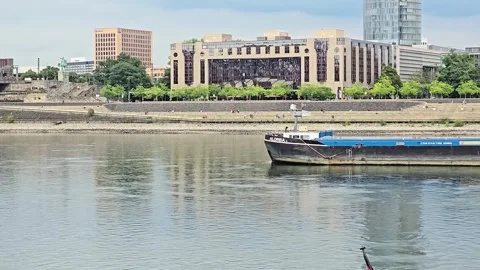 Cargo barge navigating on the Rhine river against the Cologne urban landscape Stock Footage 345097531