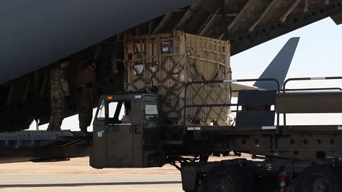 Cargo being unloaded onto k-loader from C-17 globemaster Video stock 107977913
