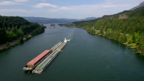 Cargo Boat Transporting Goods Down River With Trains On Banks 스톡 동영상 170091843