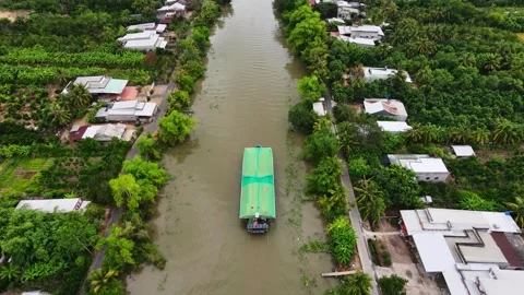 Cargo boat transporting rice husk on a Mekong Delta canal Stock Footage 337700857
