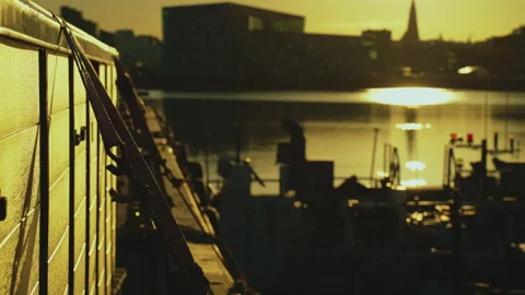 Cargo box secured with straps on a pier with blurry Reykjavik skyline and H.. Stock Footage 328460858