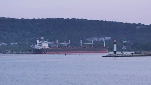 Cargo bulk carrier ship sailing near lighthouse Stock Footage 339048524