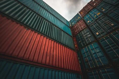 Cargo container for overseas shipping on high stack look up from ground Stock Photos