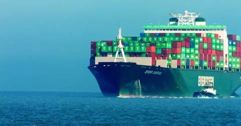 Cargo container ship and pusher tugs enter the sea port during the heat wave, 4K Stock Footage 67651345