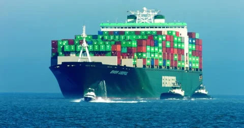 Cargo container ship and pusher tugs enter the sea port during the heat wave 4K Stock Footage 67651355