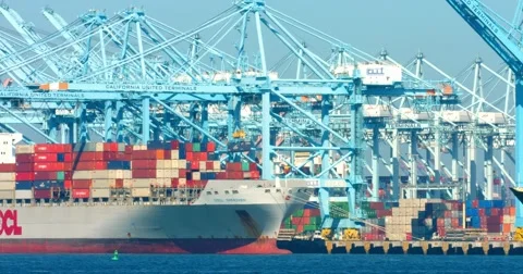 Cargo container ship and pusher tugs enter the sea port during the heat wave 4K Stock Footage 67824767