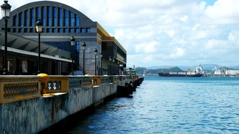 Cargo container ship behind cruise ship pier in Old San Juan Stock Footage 90530613