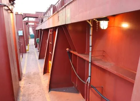 Cargo container ship deck walkway for crew. Open cargo walkway for passengers. Stock Photos