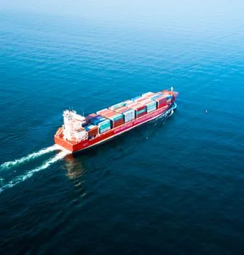Cargo Container Ship Heading into the Sea Stock Photos