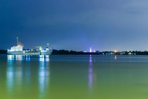 Cargo container ship logistics and transportation at night on chao phraya riv Stock Photos