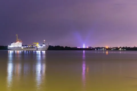 Cargo container ship logistics and transportation at night on chao phraya riv Stock Photos