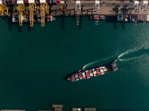Cargo Container Ship Navigating Near Industrial Terminal Cranes In Laem Cha.. Stock Photos