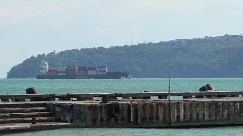 Cargo container ship sailing along a coastline 動画素材 347088966