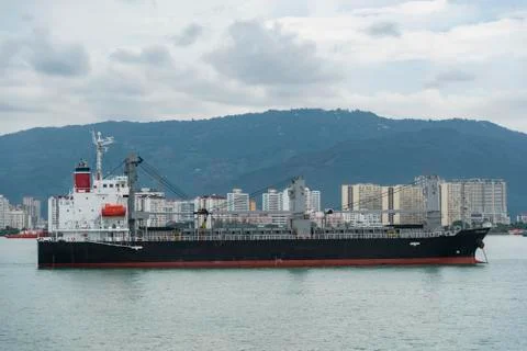 Cargo container ship sailing in still water Stock Photos
