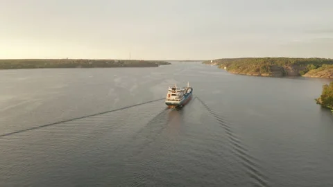 Cargo container ship sails through the sea archipelago inlet 4k Stock Footage 136094679