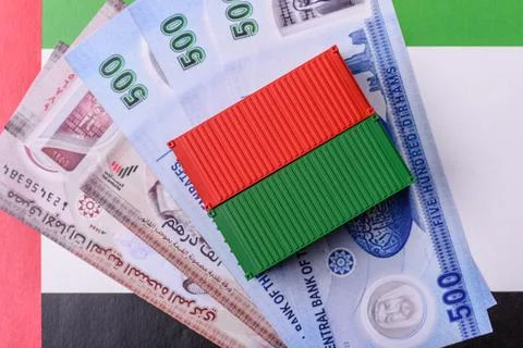 Cargo container on the uae flag as a conceptual backdrop for goods export. .. Stock Photos