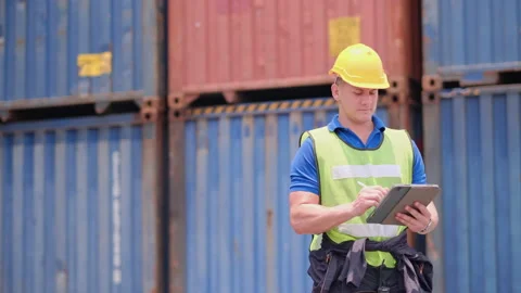 Cargo container worker or foreman look around and use tablet in workplace area Stock-Footage 146713130