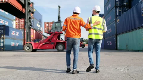 Cargo container workers walk together and discuss to check the management system Stock-Footage 146466224