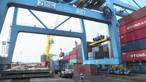 Cargo containers are moved by crane at busy port during afternoon operations Stock Footage 318203242