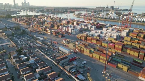 Cargo containers are stacked in a busy port 스톡 동영상 334772856